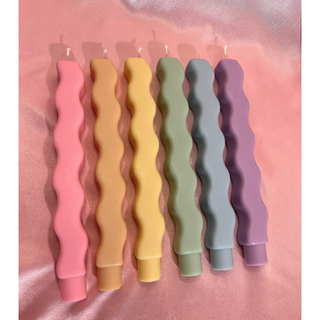 wavy tapered candles in different pastel shades