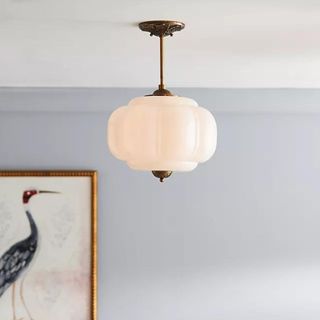 A gold pendant light hanging from the ceiling