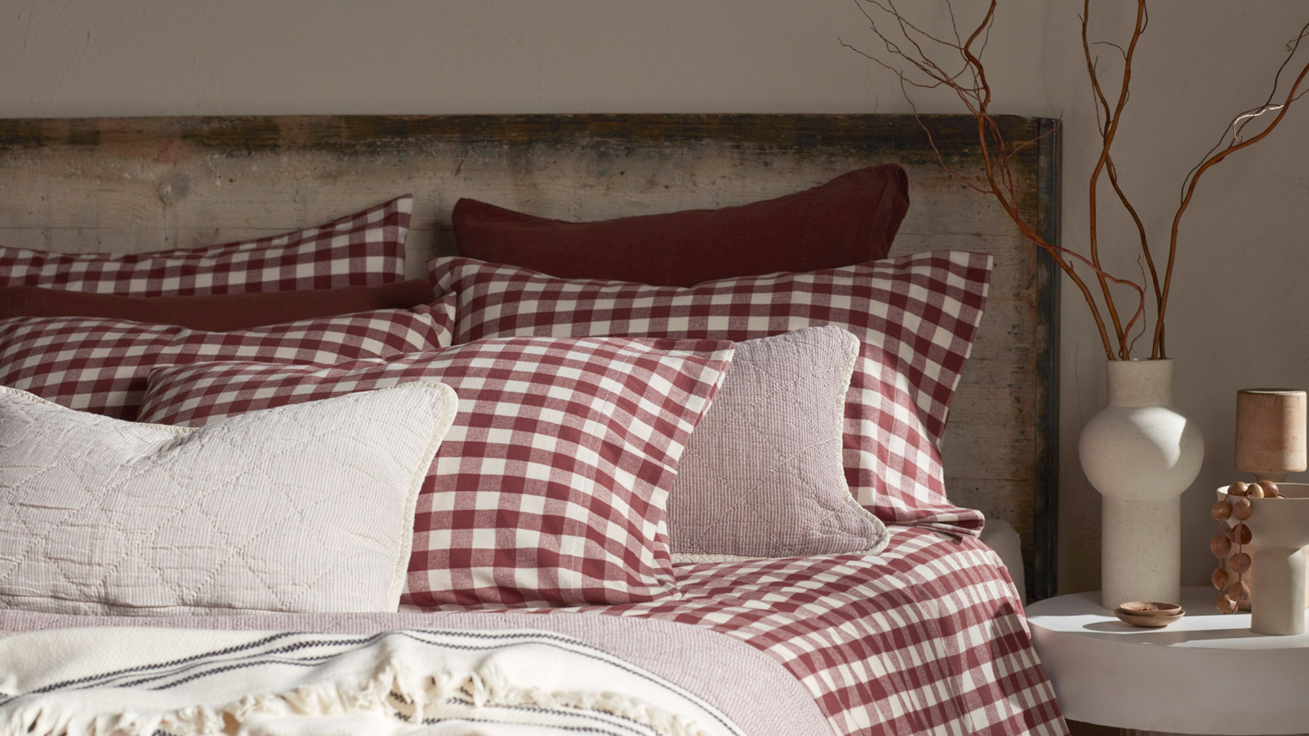 Secret Linen Store's Conker Gilbert Gingham brushed cotton bedding on a bed in a neutral bedroom