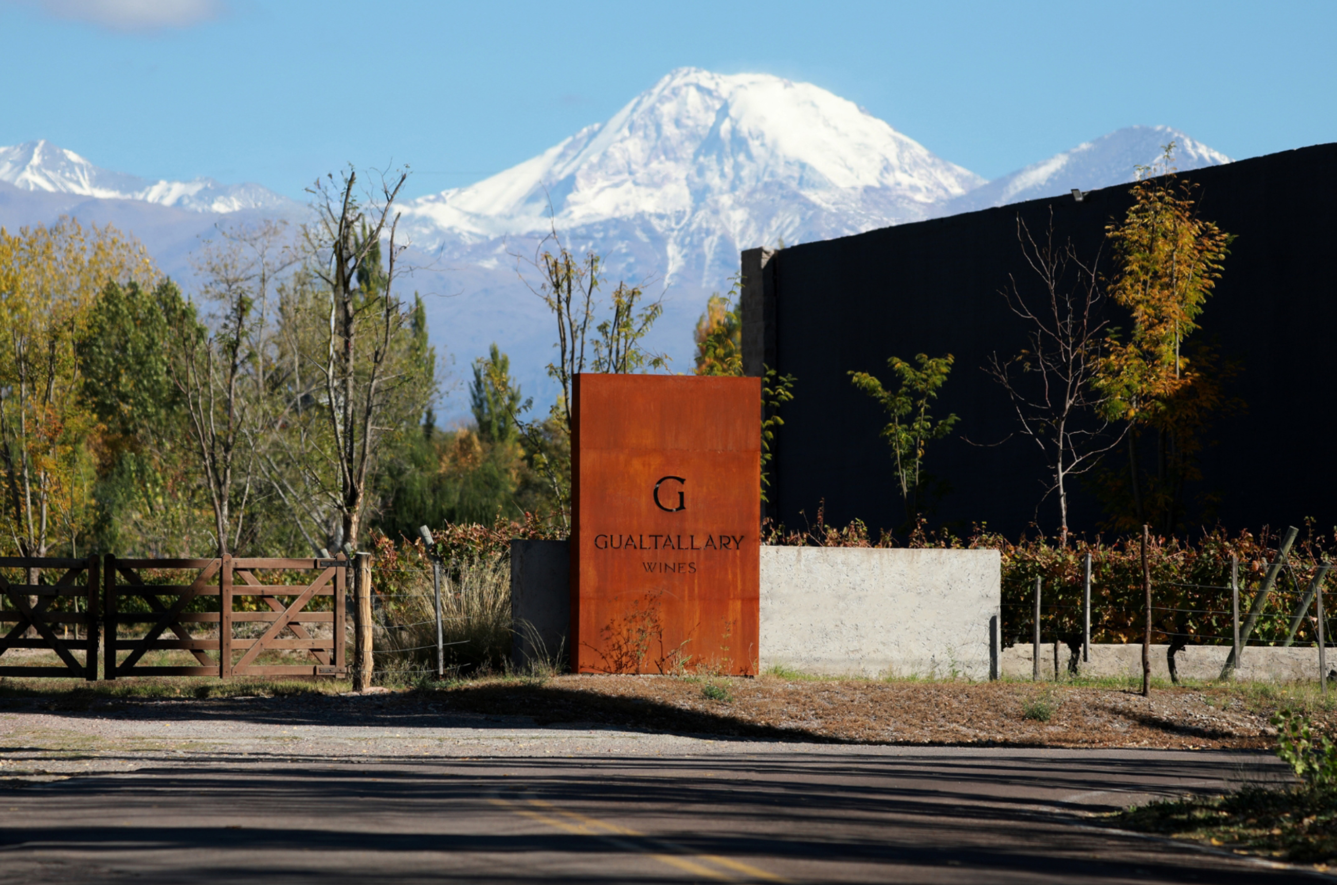 The entrance to the Gualtallary Wines winery: a large outdoor panel saying 'Gualtallary Wines' with a snowcapped mountain in the background