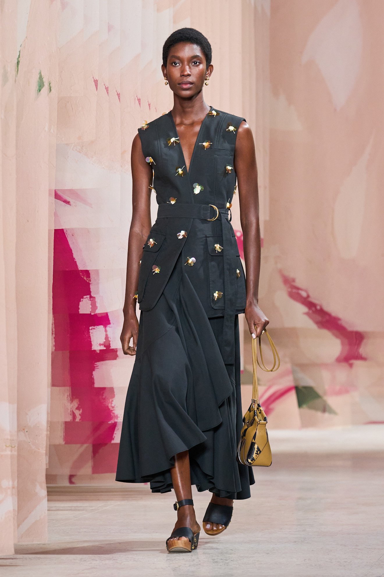 woman wearing brown and black wood clogs at Ulla Johnson Spring/Summer 2025 show