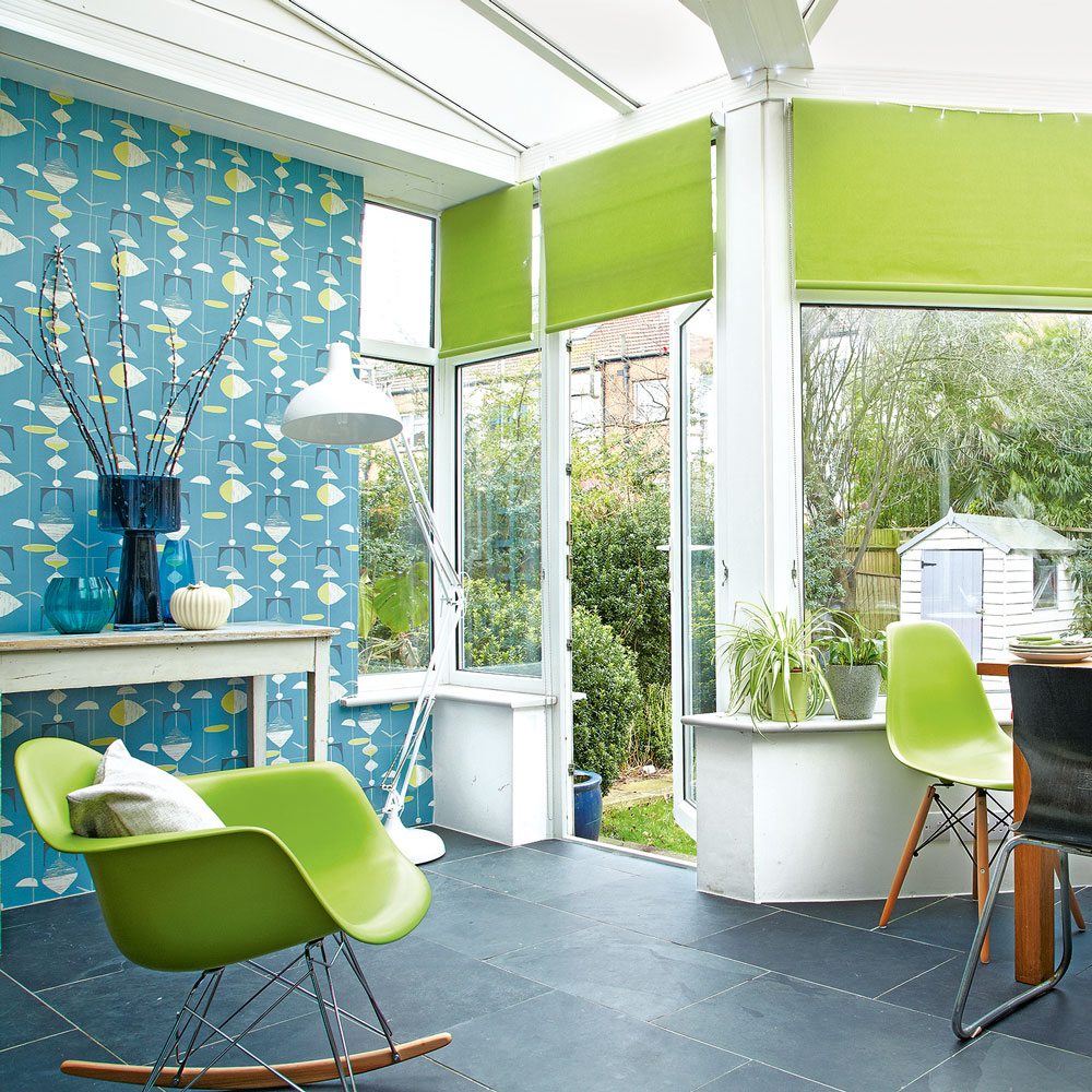 LArge white conservatory with tiled floor and feature wallpaper wall