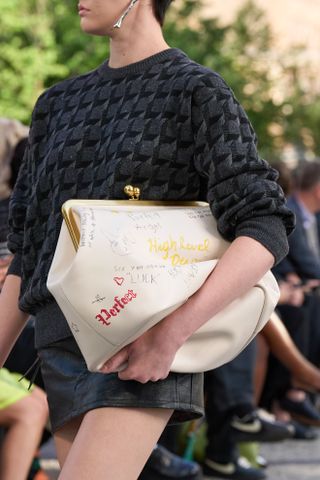 Close up images from the Coach S/S 25 show in New York showcasing the new Glovetanned Leather Kisslock Frame Bag.