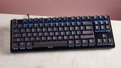 top-down view of Razer Huntsman V3 HE Magnetic Tenkeyless 8KHz on desk with pink wall in background