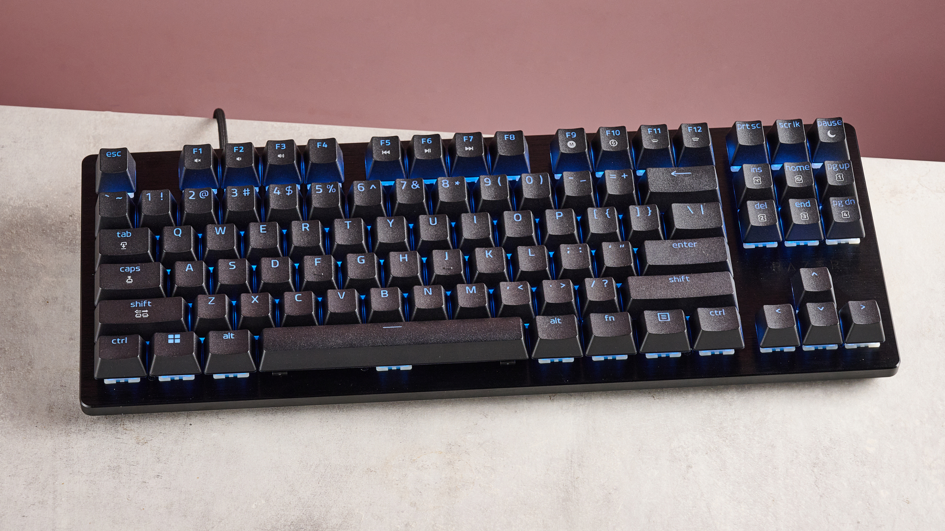 top-down view of Razer Huntsman V3 HE Magnetic Tenkeyless 8KHz on desk with pink wall in background