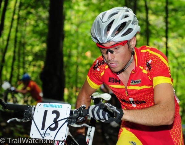 Sergio Mantecon Gutierrez (Spain) pushes his machine through some roots and rocks