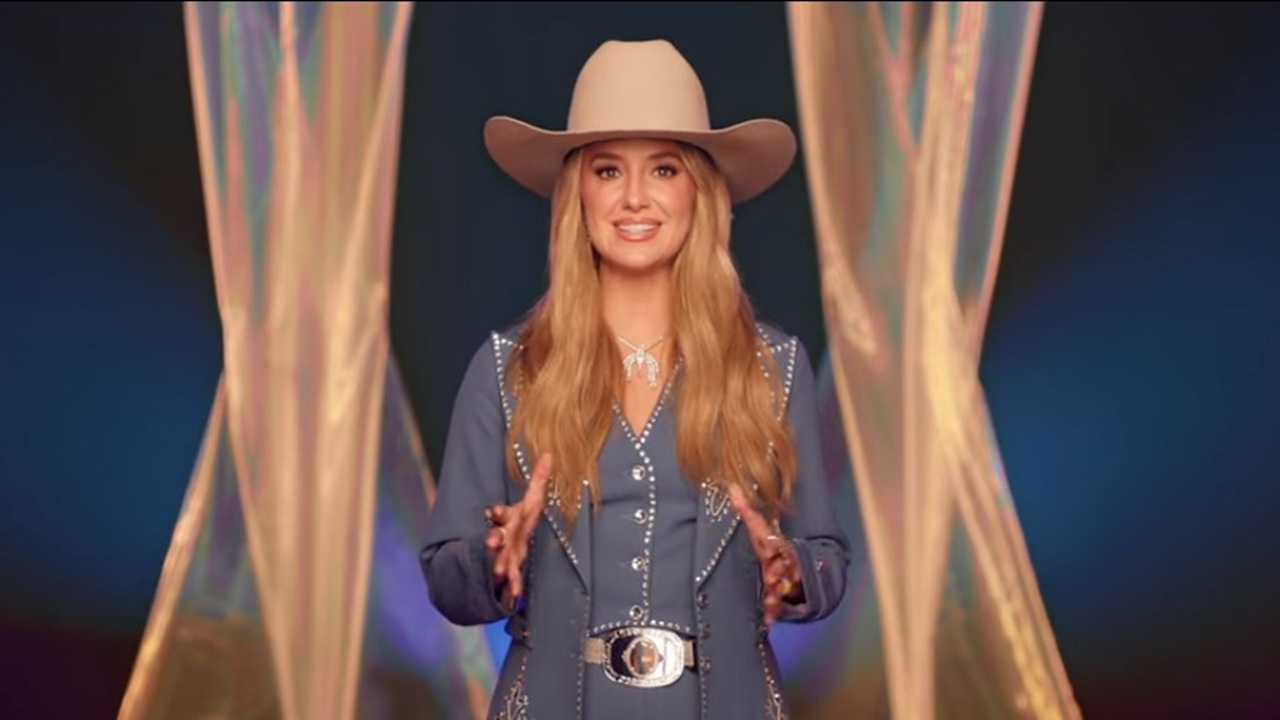 Host Lainey Wilson sports a bright smile and a cowboy hat as she faces the camera on stage at Nashville&#039;s Bridgestone Arena before the 59th Country Music Association Awards.