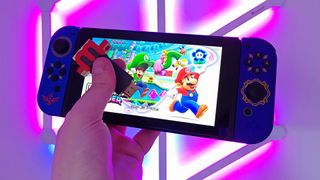 mClassic HDMI upscaler in hand with Nintendo Switch running Super Mario Wonder