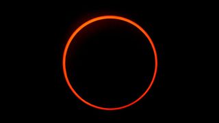 a large orange ring against a black background.