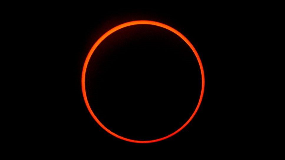 a large orange ring against a black background.