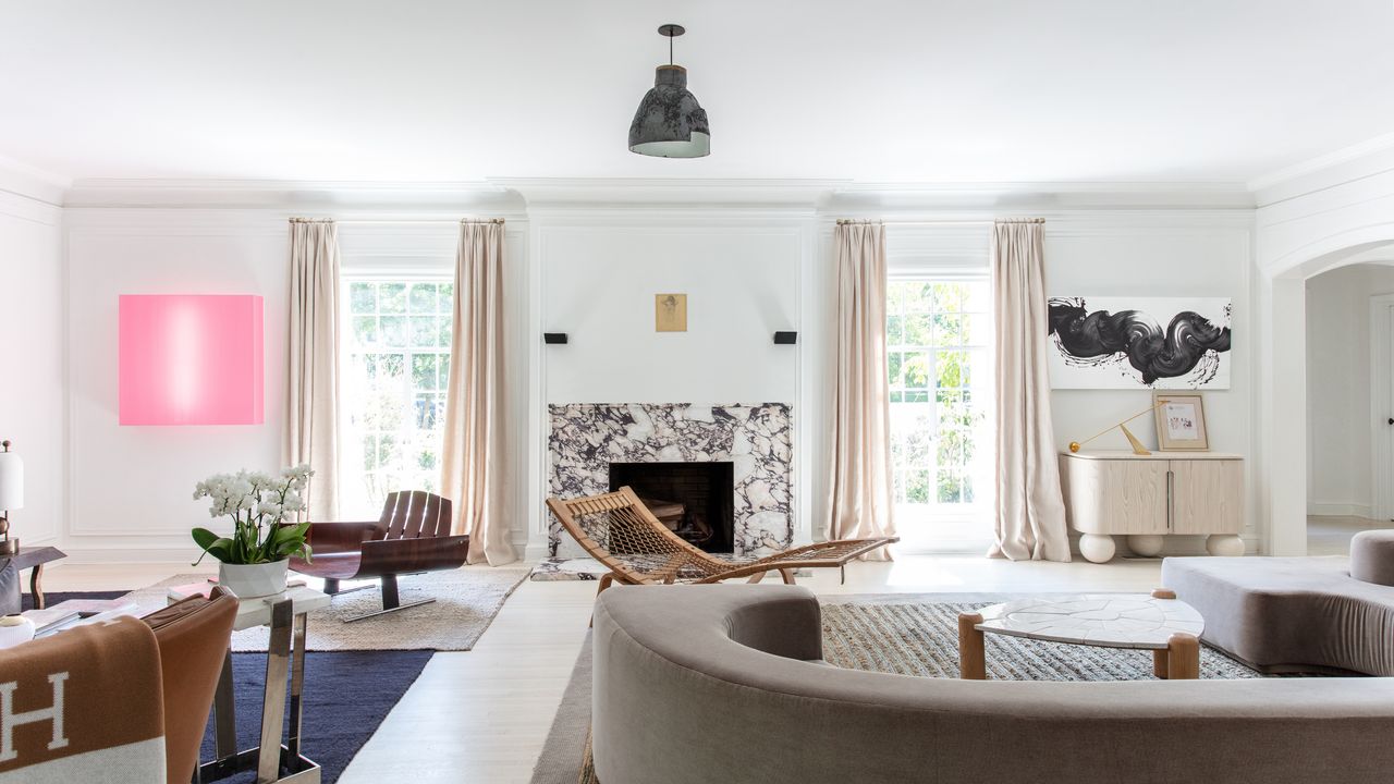 Living room with curved furniture and white walls