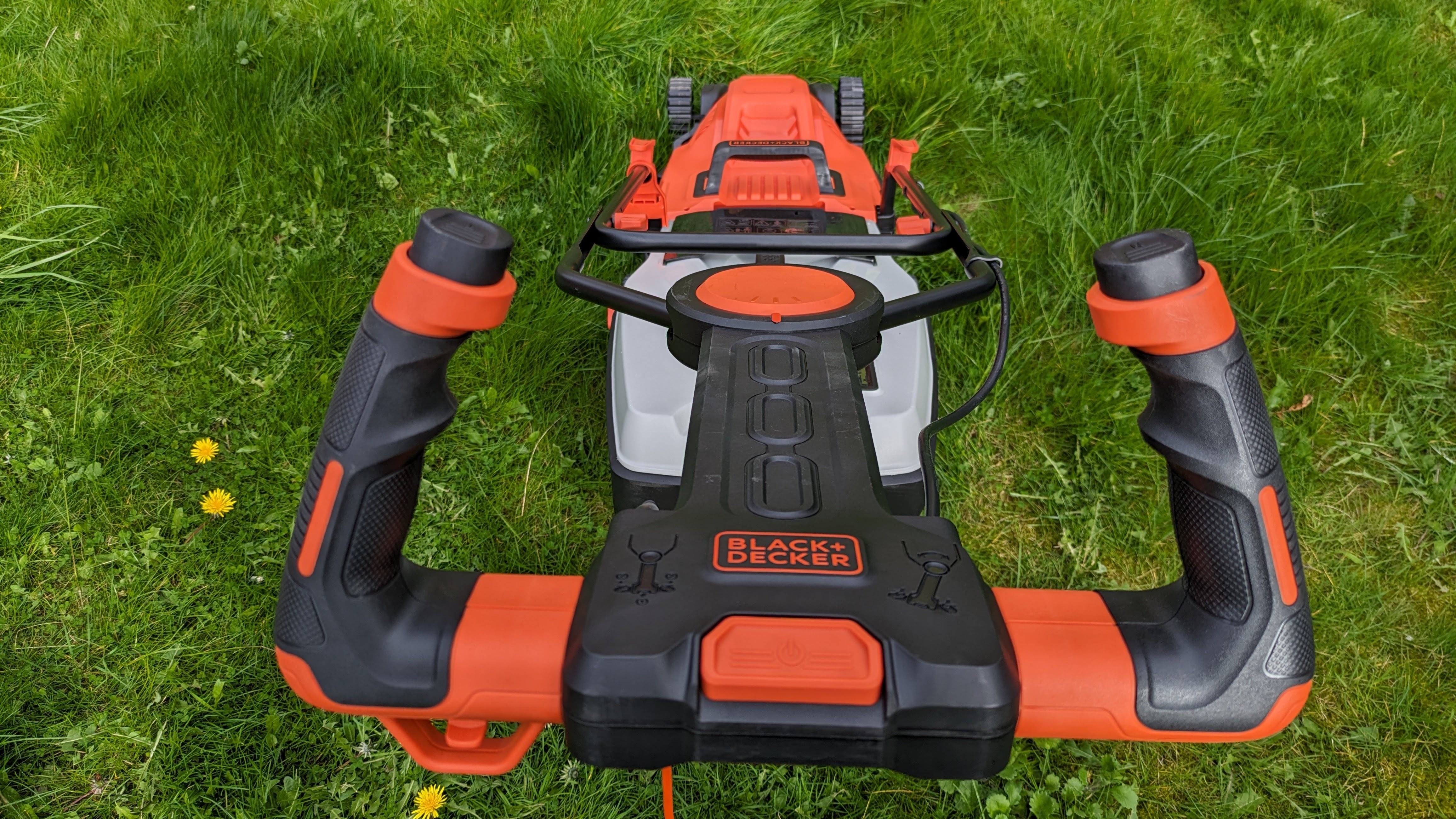 Both the US and UK versions of Black + Decker's mower have unusual upright handles, although the steering mechanisms work slightly differently.