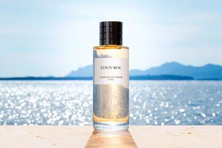 Dior Eden-Roc perfume in glass bottle on a beach
