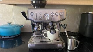 Sage the Barista Express Impress coffee maker on kitchen counter