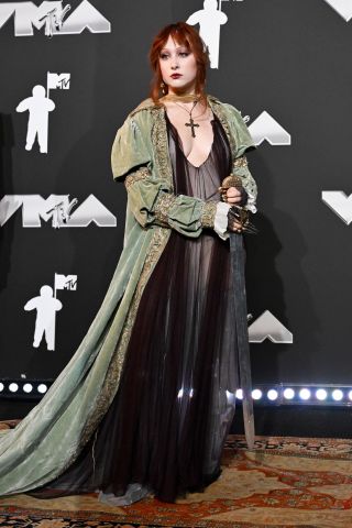 Chappell Roan at the 2024 MTV Video Music Awards held at UBS Arena on September 11, 2024 in in Elmont, New York in a sheer dress, cloak and sowrd.