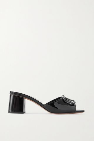 The Mules are in patent leather with black embellishments