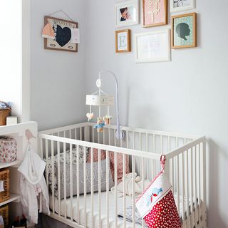 childrens room with white wall and white crib