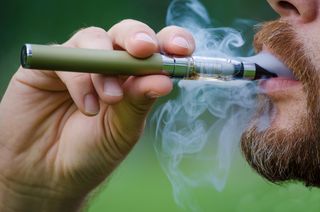 A person smoking an e-cigarette.