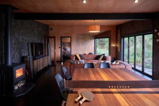 Minimalist interior with wood burner and table tennis