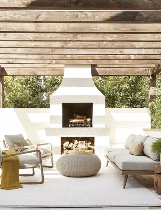 backyard outdoor living room with sofas and fire by Lulu & Georgia