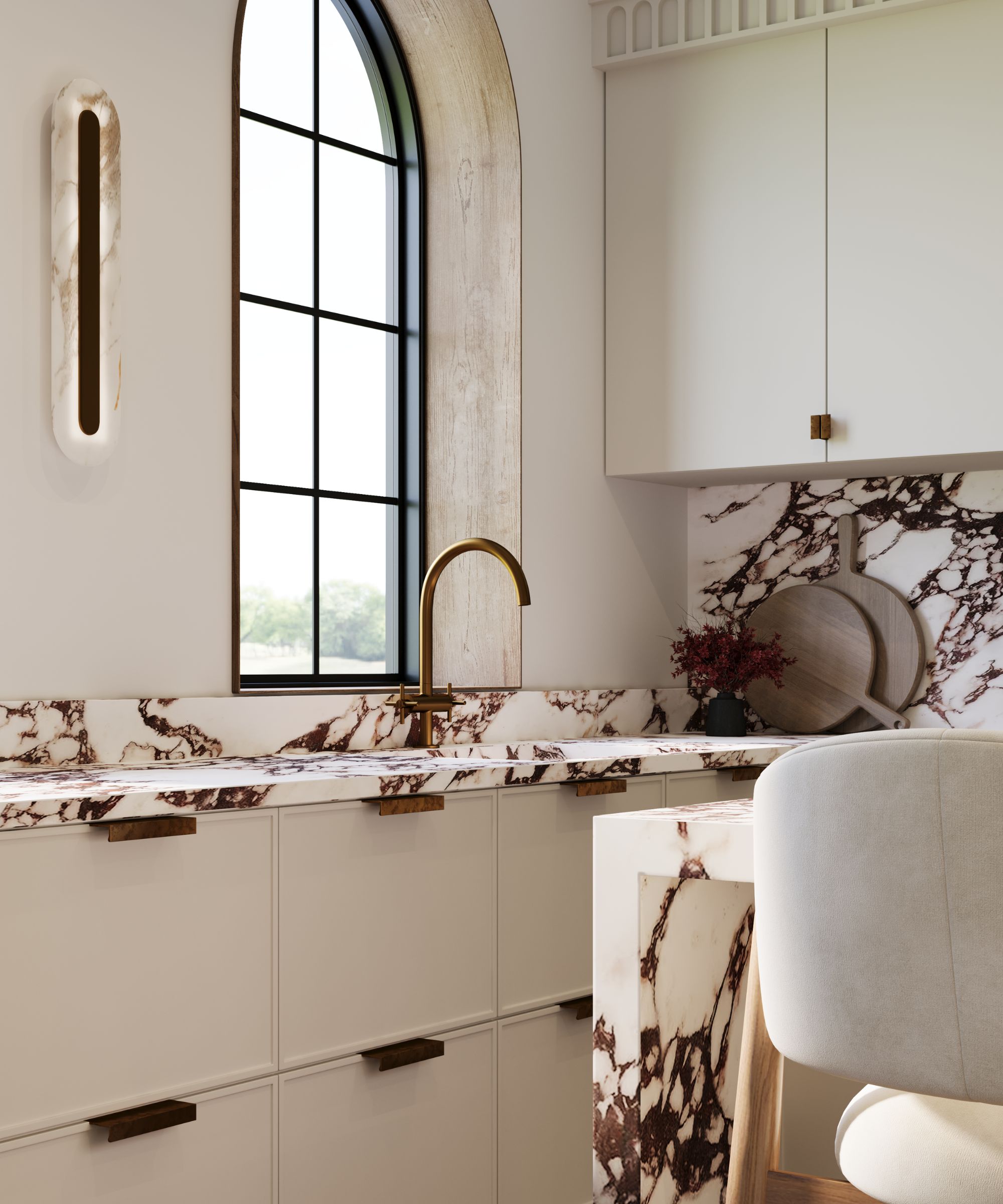 A warm white kitchen with marble countertops and bronze hardware