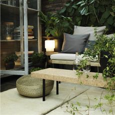 outdoor space with bench and plants on the wall 