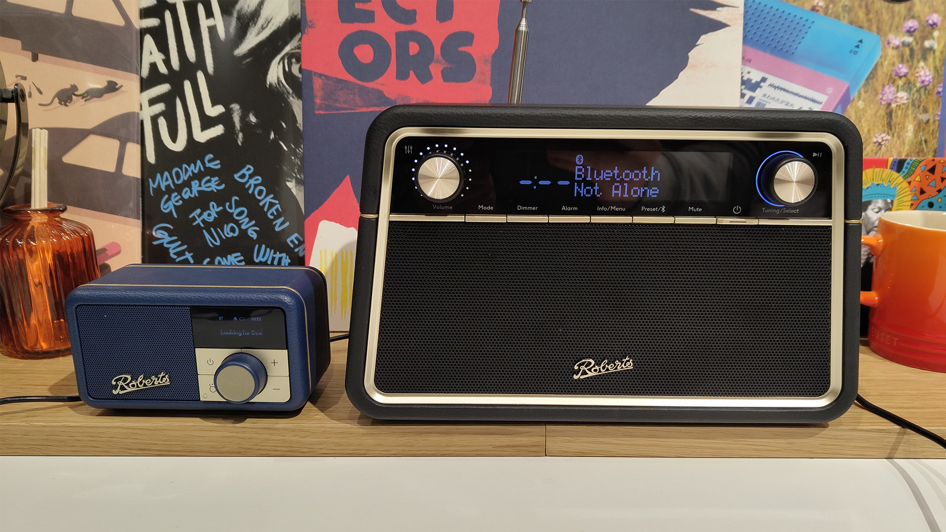 Roberts Reva radio on busy shelf next to Roberts Revival Petite 2 radio