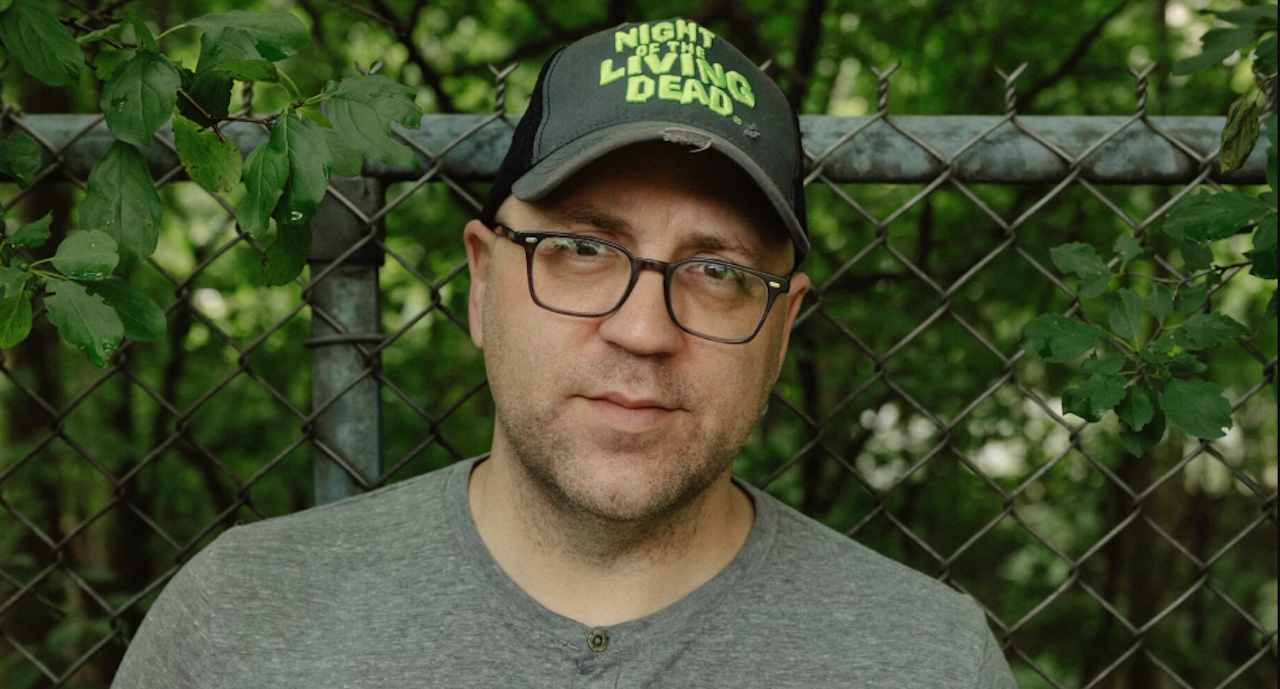 a man wearing a Night of the Living Dead hat