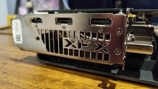 The XFX Swift RX 9060 XT on a wooden desk