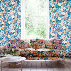living with bold yellow sofa and aquamarine wallpaper