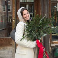 A woman with glowy, flushed skin in a winter setting