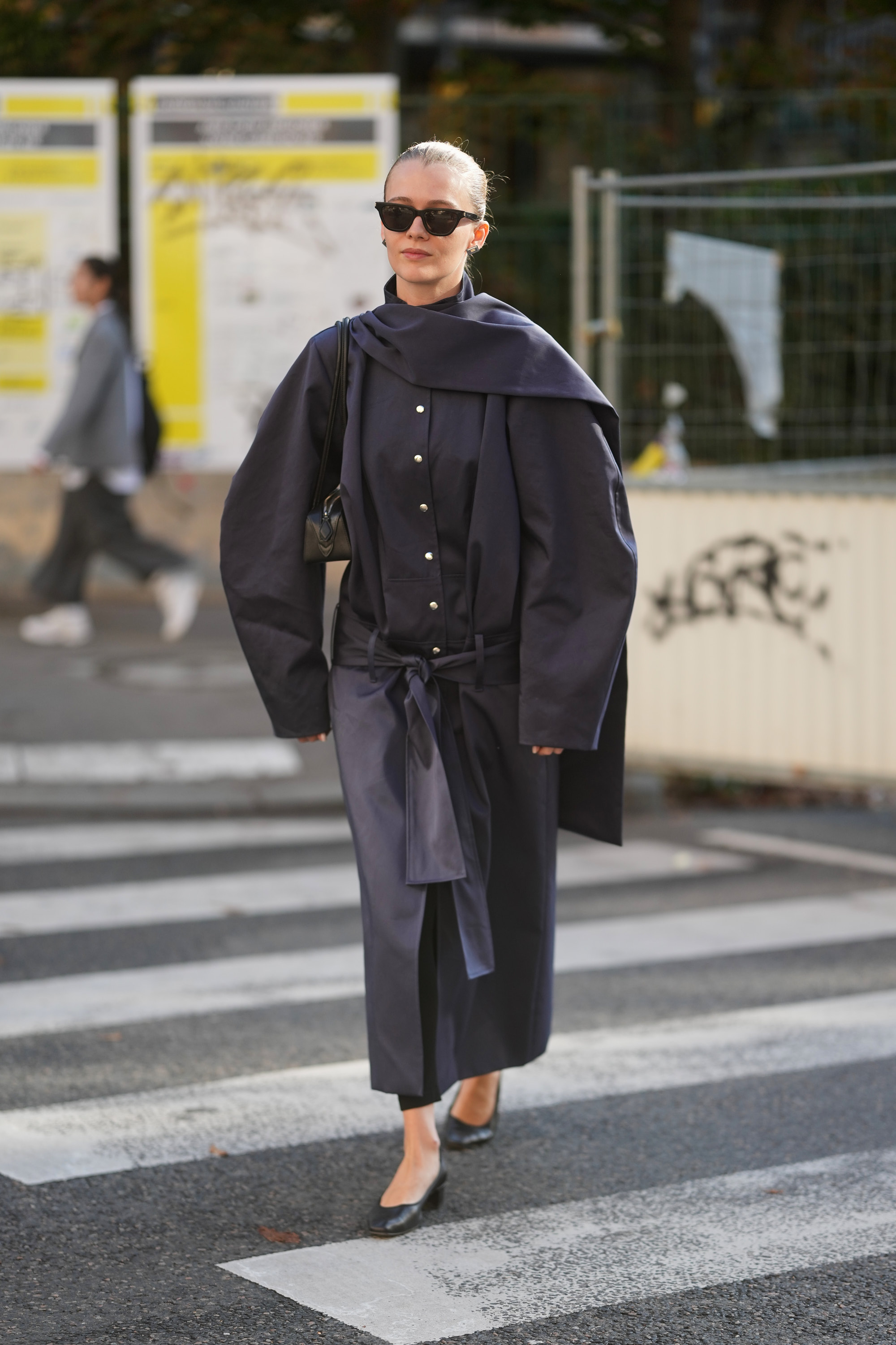 PARIS, FRANCE - OCTOBER 01: Pirrie Wright is seen wearing black sunglasses, a blue Fidan Novruzova coat, black shoes and holding a black Maison Alaia bag outside of Alainpaul during the Womenswear Spring Summer 2026 as part of Paris Fashion Week on October 01, 2025 in Paris, France. (Photo by 305pics/Getty Images)