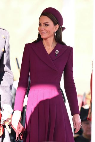 Kate wore the Prince of Wales feather pendant alongside a plum outfit