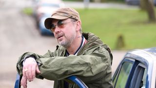 John Simm as Gray Wright leaning over an opened car door