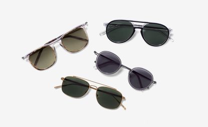 View of four pairs of Tomas Maier sunglasses in different styles and colours pictured against a light grey background