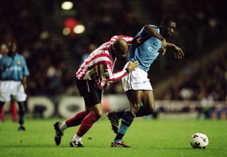 Manchester City's Dickson Etuhu competes for the ball with Sheffield United's George Santos in October 2001.