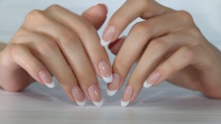 Hands with a classic French manicure