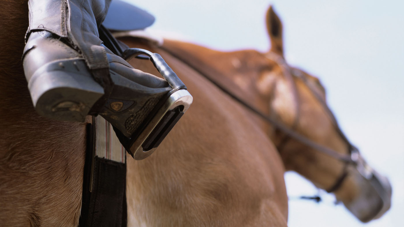 Rider atop horse with boot in stirrup. Image shot 02/2006. Exact date unknown.