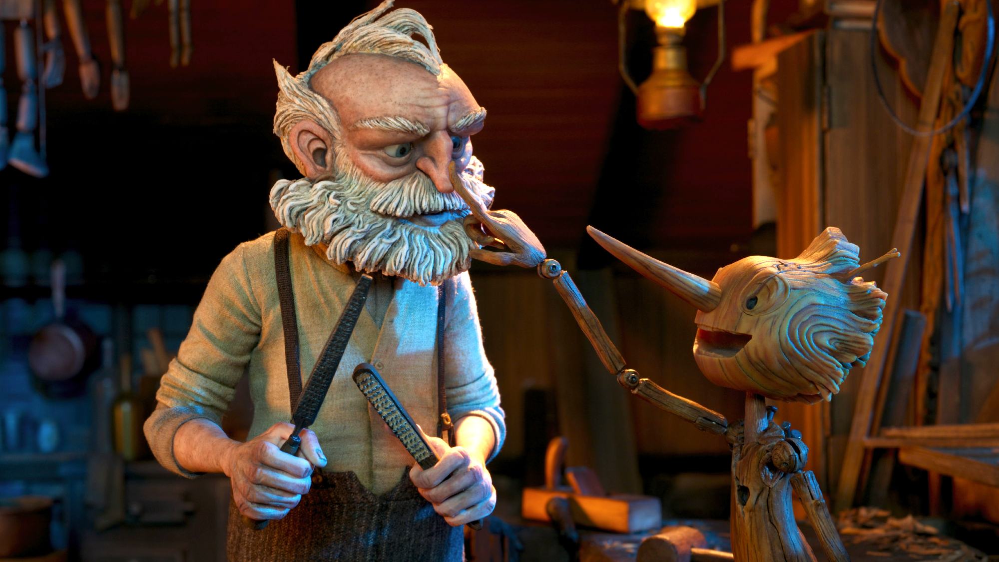 (L-R) Gepetto (voiced by David Bradley) and Pinocchio in Guillermo del Toro's Pinocchio