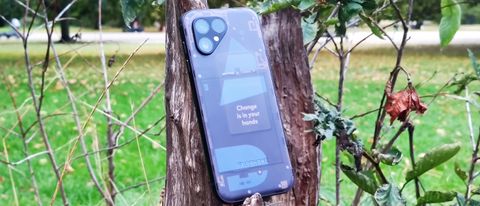 The Fairphone 5 leaning on a tree stump.