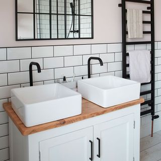 bathroom with white sinks and white tiles