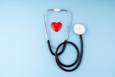 Medical Stethoscope and Heart on Blue Background Health Care Insurance Concept - stock photo