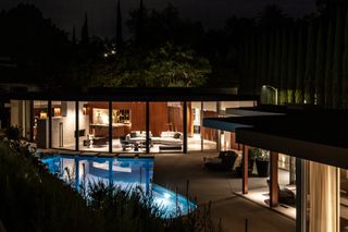 exterior view at night of cove way, a midcentury home restored by Sophie goineau