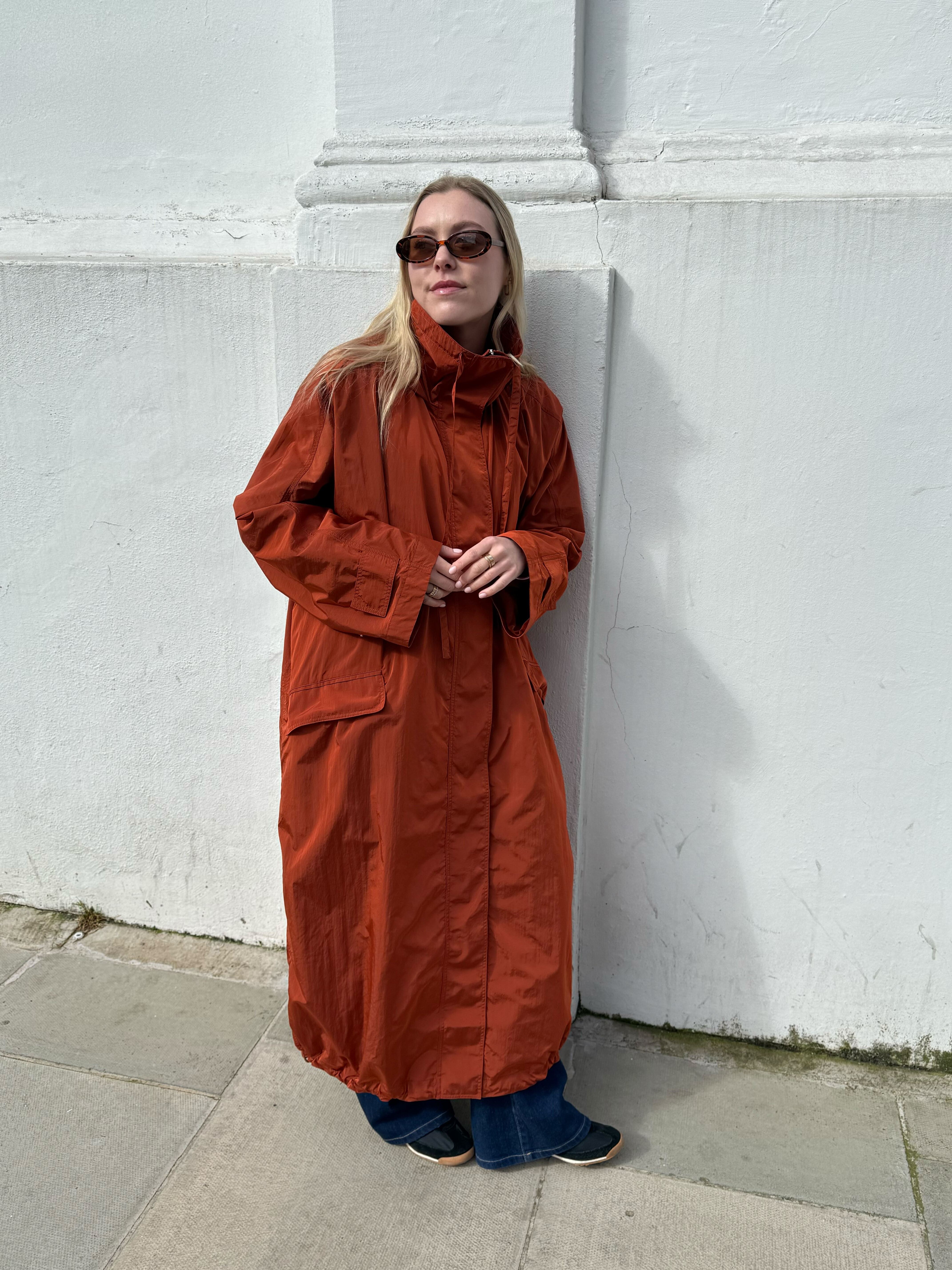 An image of Who What Wear UK shopping editor Florrie Alexander wearing an &amp;amp; Other Stories raincoat.