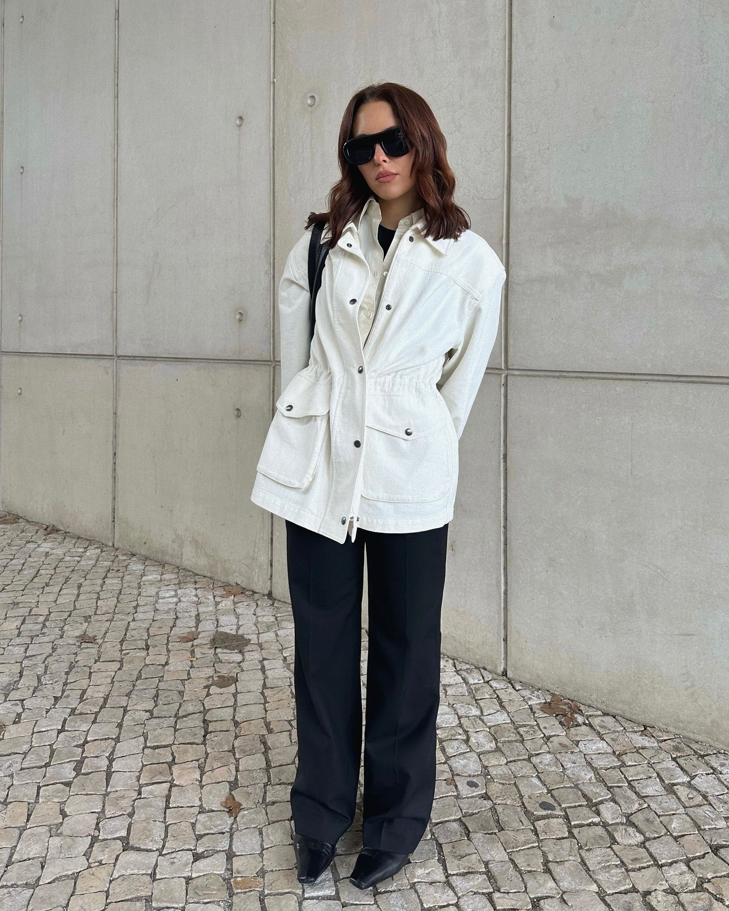Woman in white technical jacket.