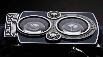 A detailed, horizontal view of the Rollei-inspired dual-lens watch face highlighting its sub-dials, branding, and polished casing.