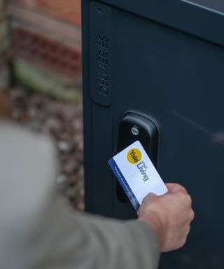 Close up of someone opening a smart locker using a Yale key card