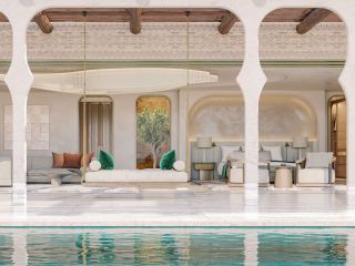 A sumptuously decorated hotel inspired by the Middle East featured bright, pastel-shaded colors, soft furniture and lines, and a hall facing water.