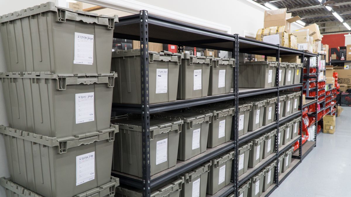 Each of these gray bins contains the components of exactly one custom-ordered gaming PC.