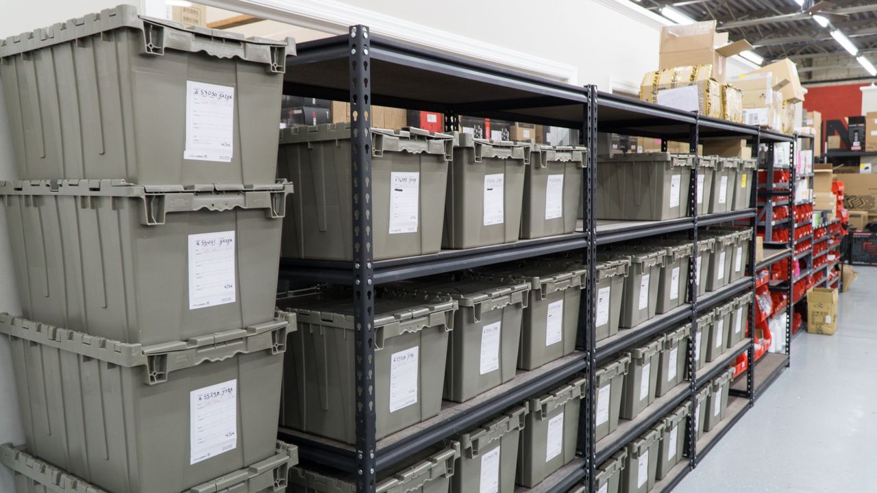 Each of these gray bins contains the components of exactly one custom-ordered gaming PC.